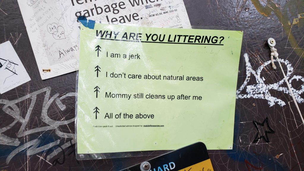 sign discussing why people litter on trails
