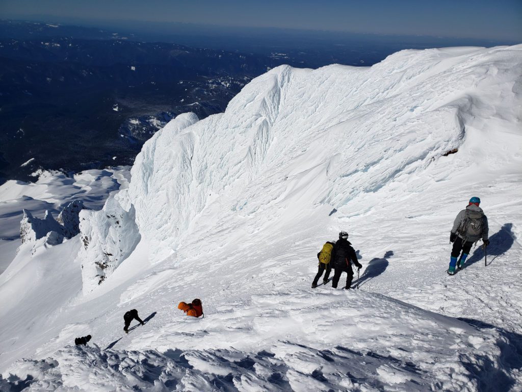 climbers descending the old chute near the pearly gates on mount hood
