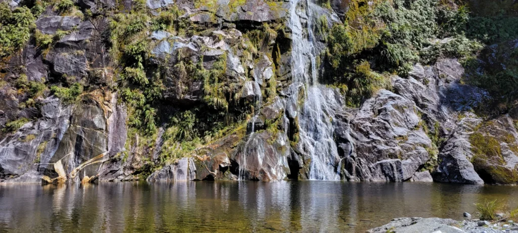 mirror lake waterfall along milford track