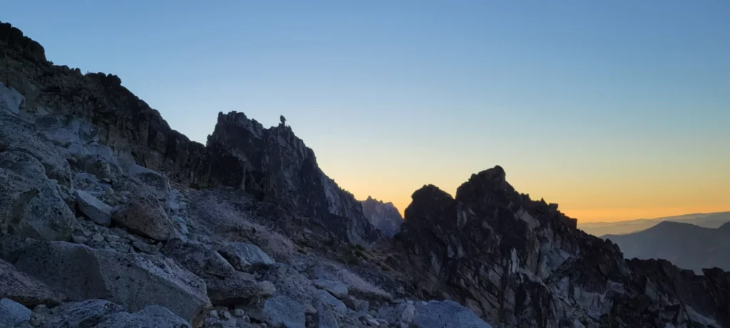 sunrise over sherpa peak from cascadian couloir on mount stuart